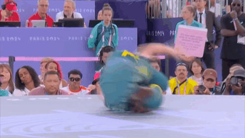 A Man Is Doing A Trick In Front Of A Crowd At The Paris 2024 Games GIF