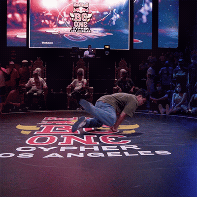 A Man Is Doing A Trick In Front Of A Sign That Says Red Bull Bc One Oypher Los Angeles GIF