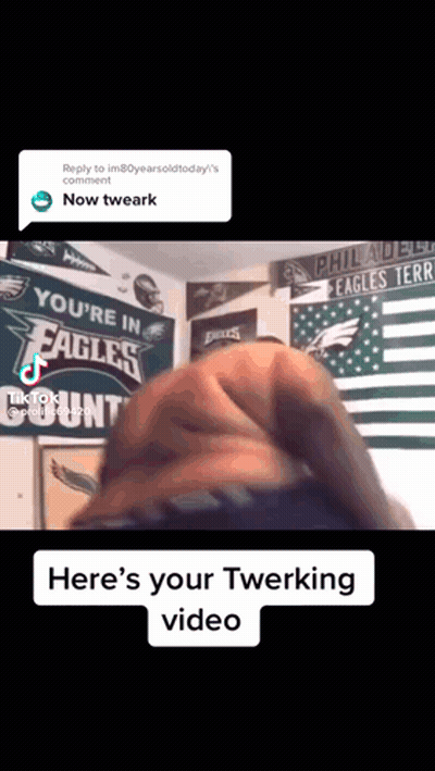 A Man Is Doing A Twerking In Front Of A Philadelphia Eagles Sign GIF