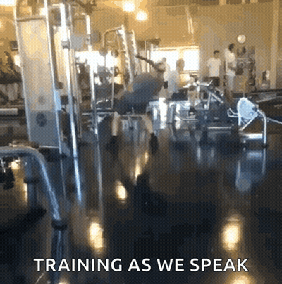 A Man Is Doing Exercises In A Gym With The Words Training As We Speak GIF