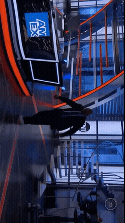 A Man Is Doing Push Ups In Front Of A News Desk That Says Am Ex GIF