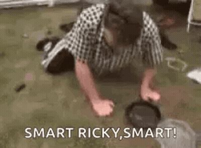 A Man Is Doing Push Ups On The Floor While A Dog Looks On . GIF
