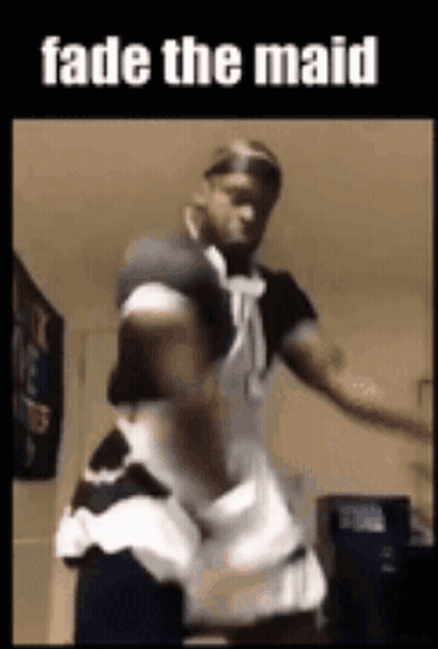 a man is dressed as a maid and dancing .