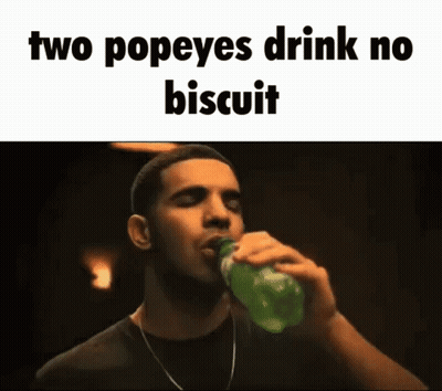 A Man Is Drinking A Bottle Of Popeye 'S Drink . GIF