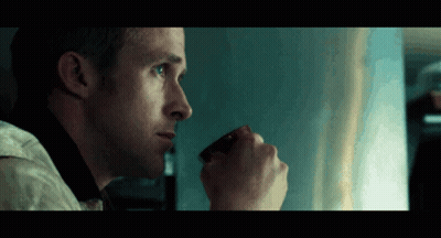 A Man Is Drinking A Cup Of Coffee And Looking Out The Window GIF