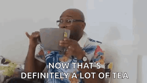 A Man Is Drinking A Cup Of Tea From A Large Mug . GIF