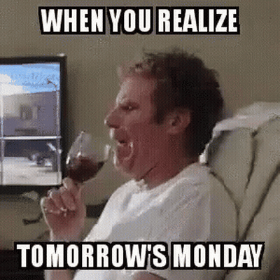 A Man Is Drinking A Glass Of Wine While Sitting In A Chair In Front Of A Computer Screen . GIF