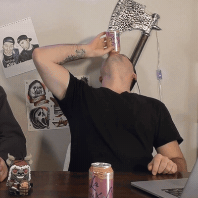 A Man Is Drinking From A Can That Says La Rock GIF