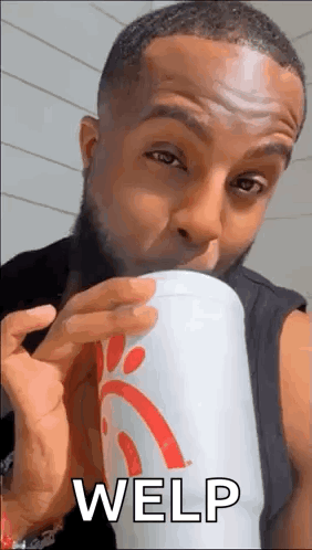 A Man Is Drinking From A Chick-Fil-A Cup While Making A Funny Face . GIF