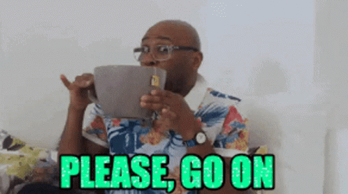 A Man Is Drinking From A Mug With The Words Please Go On Written On It GIF