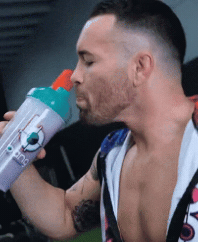 A Man Is Drinking From A Purple Bottle That Says ' King ' On It GIF
