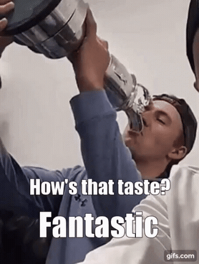 A Man Is Drinking From A Trophy With A Caption That Says How 'S That Taste Fantastic GIF