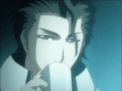 A Man Is Drinking From A White Cup . GIF