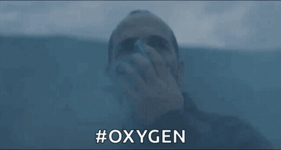 A Man Is Drinking Oxygen From A Bottle While Swimming In The Water . GIF