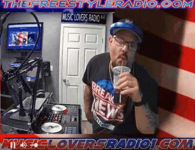 A Man Is Drinking Through A Straw In Front Of A Sign That Says Music Lovers Radio GIF