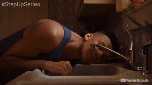 A Man Is Drinking Water From A Faucet With The Hashtag Stepupseries On The Bottom GIF
