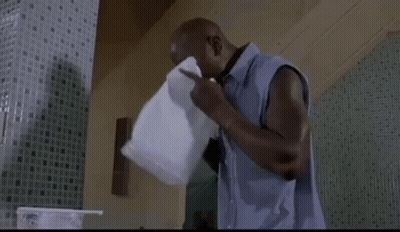 A Man Is Drinking Water From A Plastic Container . GIF