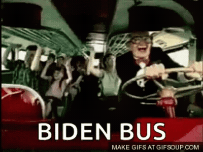 A Man Is Driving A Bus With A Crowd Of People On It And The Words Biden Bus On The Side . GIF