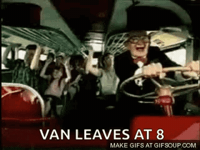 a man is driving a bus with a crowd of people on the back .