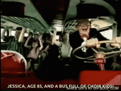 A Man Is Driving A Bus With A Group Of People . GIF