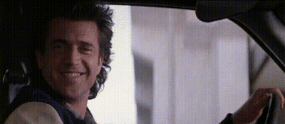 A Man Is Driving A Car And Smiling . GIF