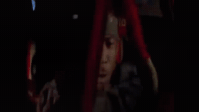 A Man Is Driving A Car And Talking On A Cell Phone While Holding A Gun . GIF