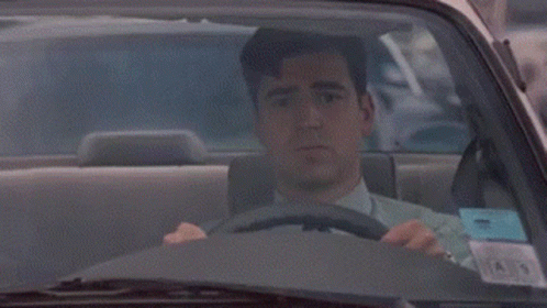 A Man Is Driving A Car And The Word Traffic Jam Is On The Side GIF