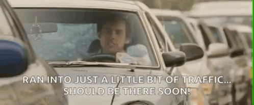 A Man Is Driving A Car In A Traffic Jam While Holding A Baby . GIF