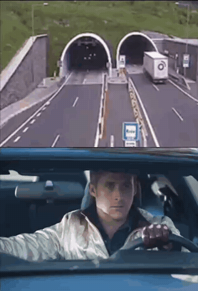 A Man Is Driving A Car Through A Tunnel And Looking Out The Window . GIF