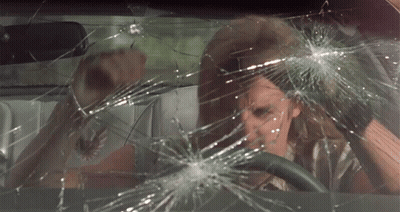 A Man Is Driving A Car With A Broken Windshield GIF