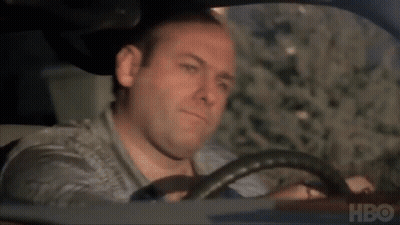 A Man Is Driving A Car With Hbo Written On The Bottom Of The Screen . GIF