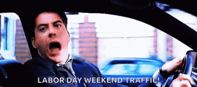 A Man Is Driving A Car With The Words Labor Day Weekend Traffic Written On The Screen GIF