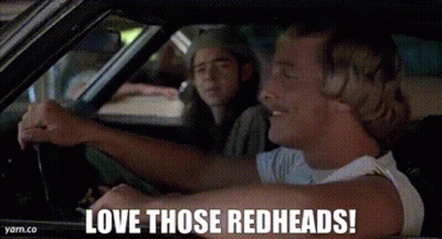 A Man Is Driving A Car With The Words `` Love Those Redheads ! '' Written On The Screen . GIF