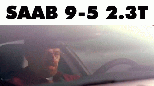 A Man Is Driving A Car With The Words Saab 9-5 2.3T Above Him GIF