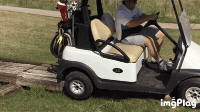 A Man Is Driving A Golf Cart With The Number 35 On The Back GIF