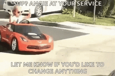 A Man Is Driving A Red Toy Car On A Street . GIF