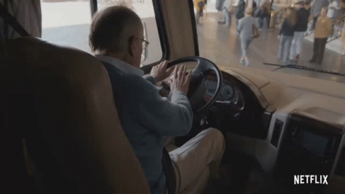 A Man Is Driving A Rv With Netflix Written On The Bottom Of The Screen GIF