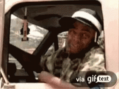 A Man Is Driving A Truck With A Gif Text Sticker On The Bottom GIF