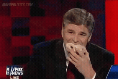 A Man Is Eating A Donut On Fox News GIF