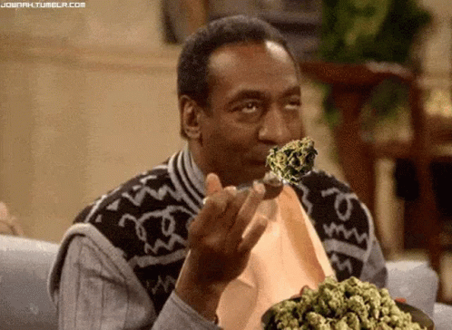 A Man Is Eating A Piece Of Marijuana With A Fork . GIF