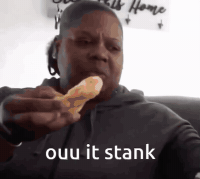 A Man Is Eating A Piece Of Pizza With The Words " Ouu It Stank " Written Below Him GIF