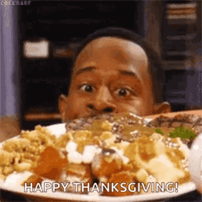 A Man Is Eating A Plate Of Food With The Words `` Happy Thanksgiving '' Written On It . GIF