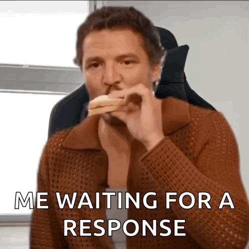 A Man Is Eating A Sandwich With The Words " Me Waiting For A Response " Below Him GIF