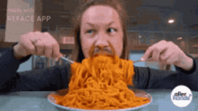 A Man Is Eating Spaghetti With A Fork And Knife GIF