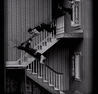 A Man Is Falling Down A Set Of Stairs In A Black And White Photo GIF