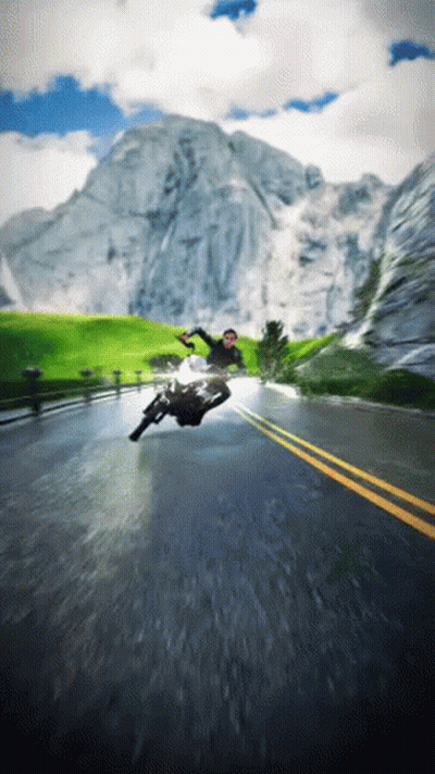 A Man Is Falling Off A Motorcycle On A Road GIF