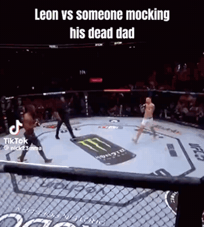 A Man Is Fighting Another Man In A Boxing Ring With A Monster Energy Logo On The Ground . GIF