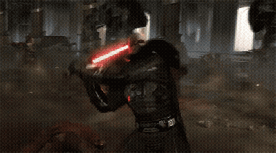 A Man Is Fighting Another Man With A Lightsaber In A Dark Room GIF