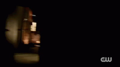 A Man Is Fighting Another Man With A Sword In A Dark Alleyway . GIF