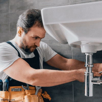 A Man Is Fixing A Sink Pipe With A Wrench GIF